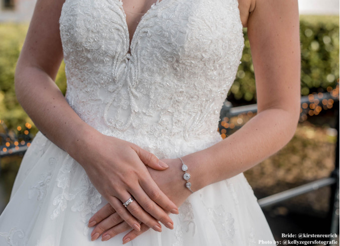 Bruid draagt zilveren bruidsarmband om pols
