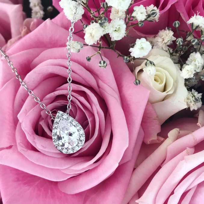Zilveren bruidsketting op roze roos