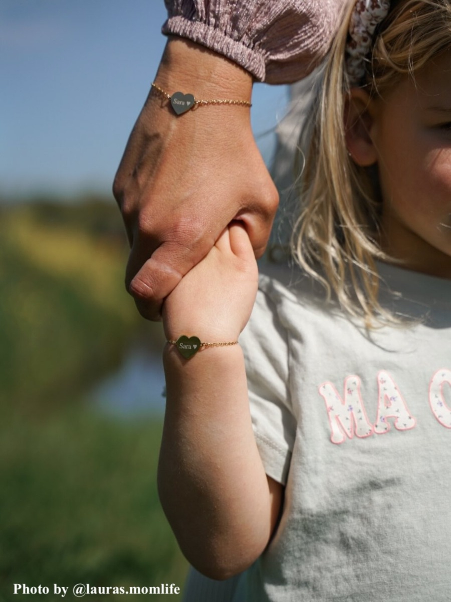 Influencer draagt gouden graveerbare armband met hartje