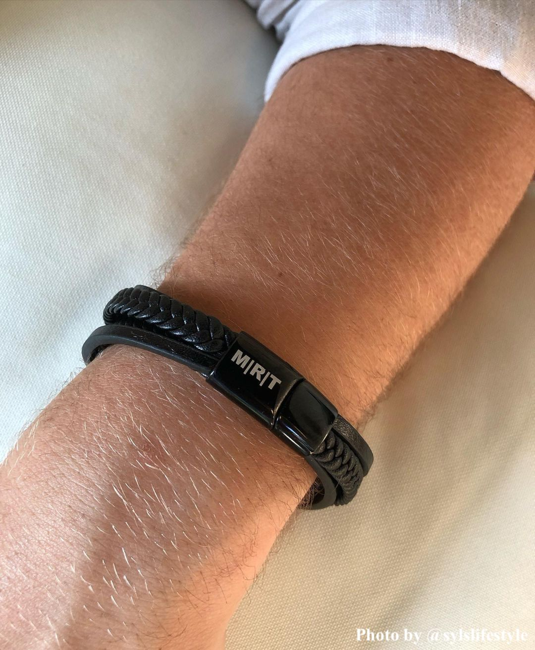 zwarte armband met meerdere bandjes en gravering in doosje met roze blaadjes
