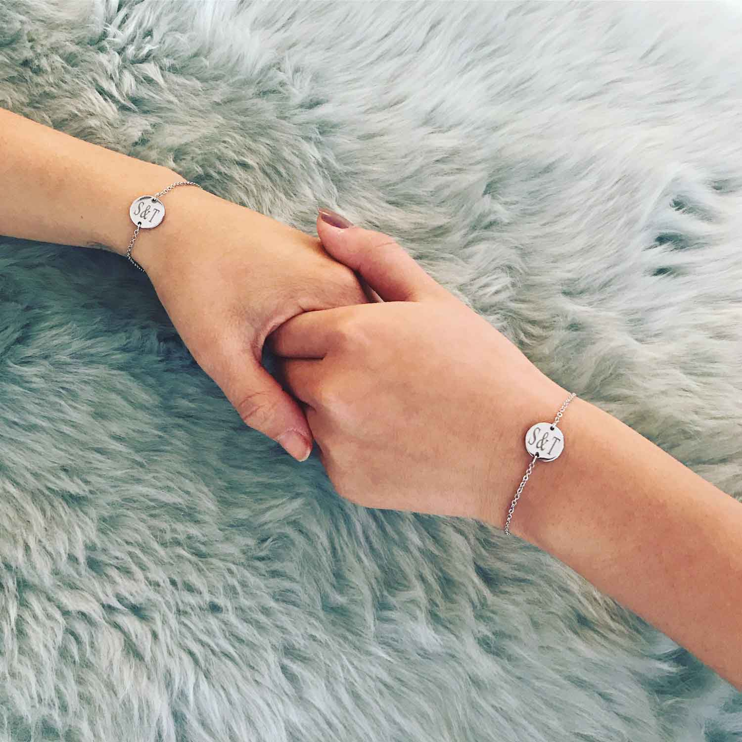 Twee zussen dragen stainless steel armband met graveerbare bedel