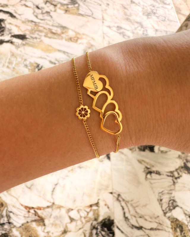Gouden armparty met hartjes en bloem