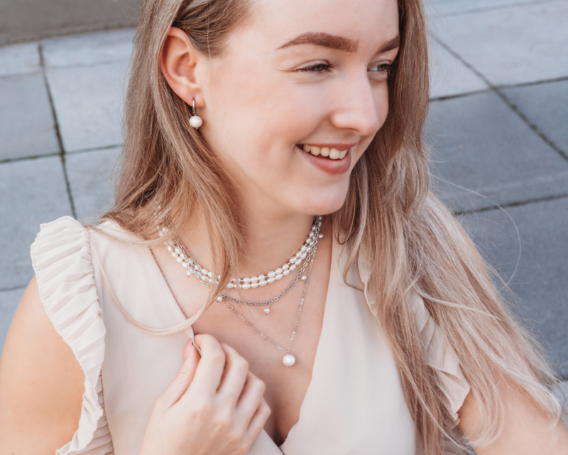 Model draagt zilveren parelkettingen