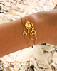Gouden armparty met hartjes en bloem