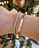 Gouden armparty met steentjes en gravering
