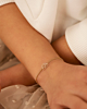 Gouden kinder armband met regenboog bedeltje