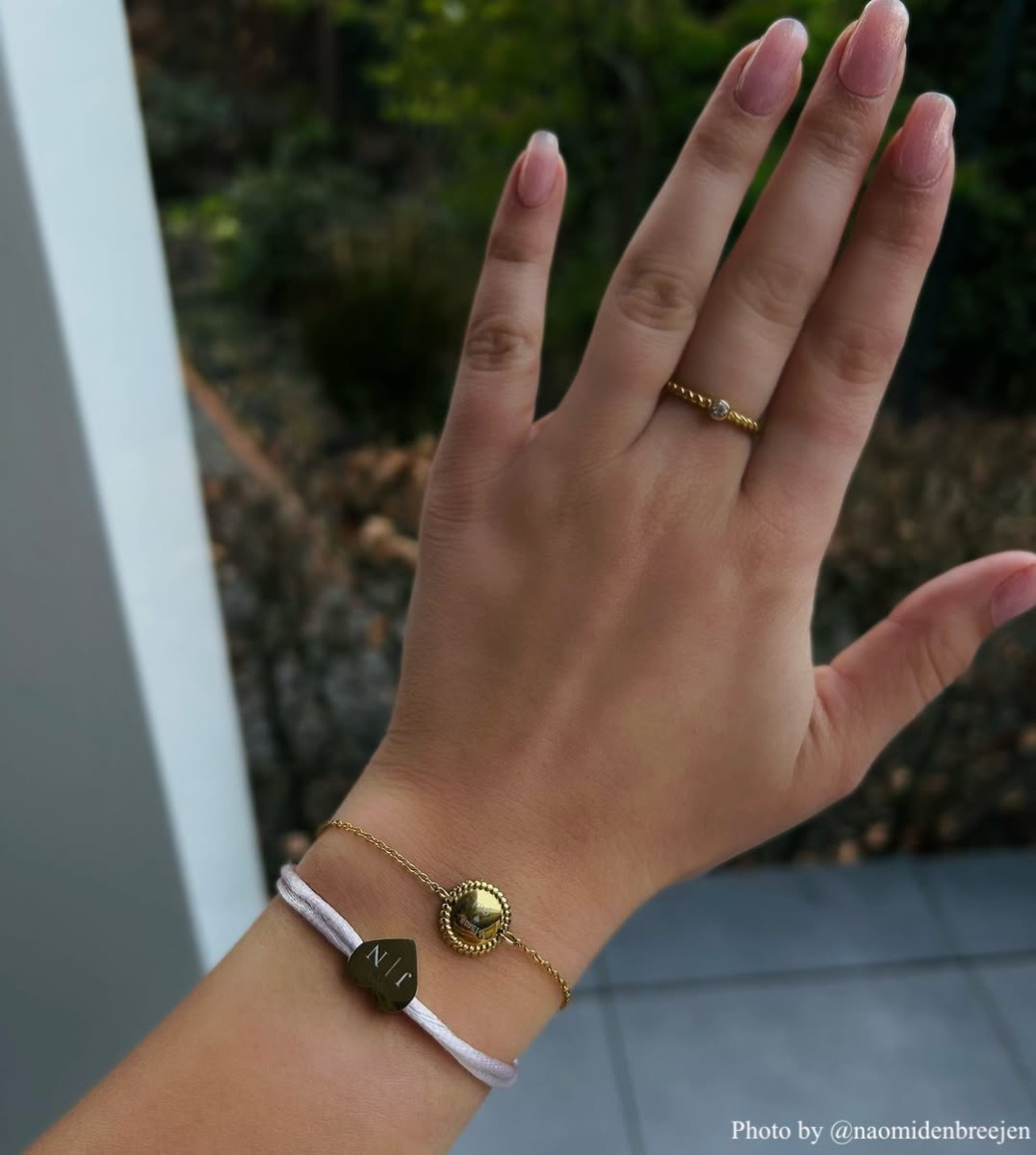Influencer met ring en gegraveerde armbanden