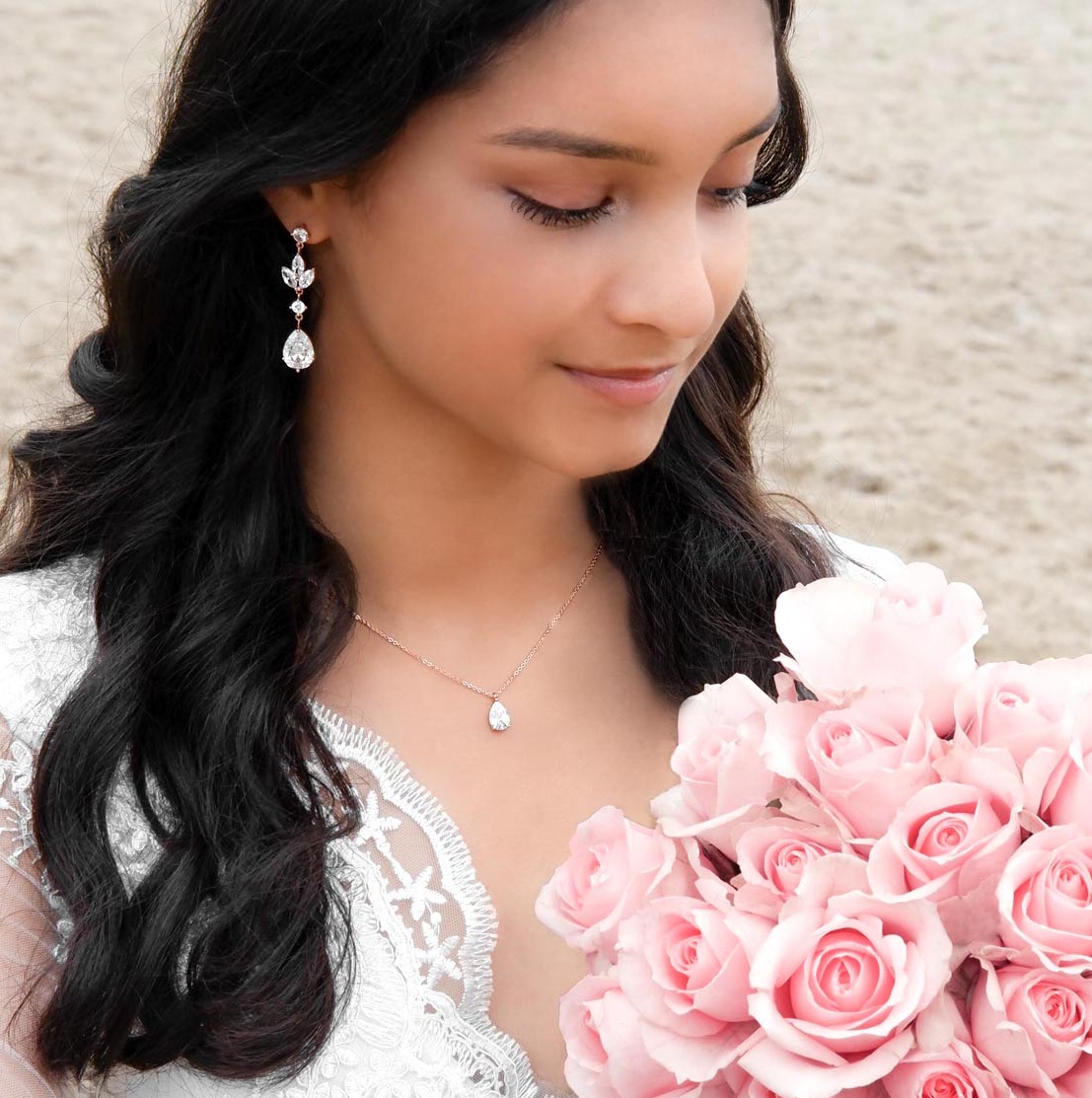 bruid met rose gouden sieraden set en roze rozen