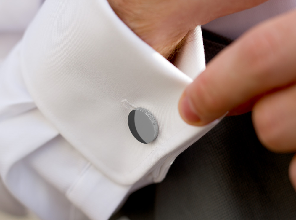 Bruidegom draagt ronde manchetknoop in witte blouse