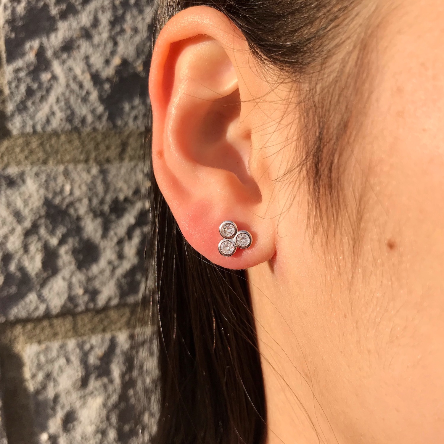 Vrouw draagt subtiele driehoek oorbelletjes zilver