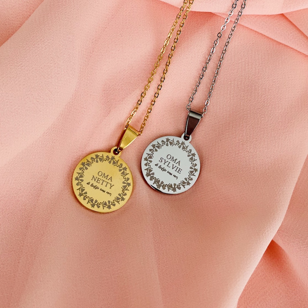 gouden en zilveren ketting met gravering op satijn