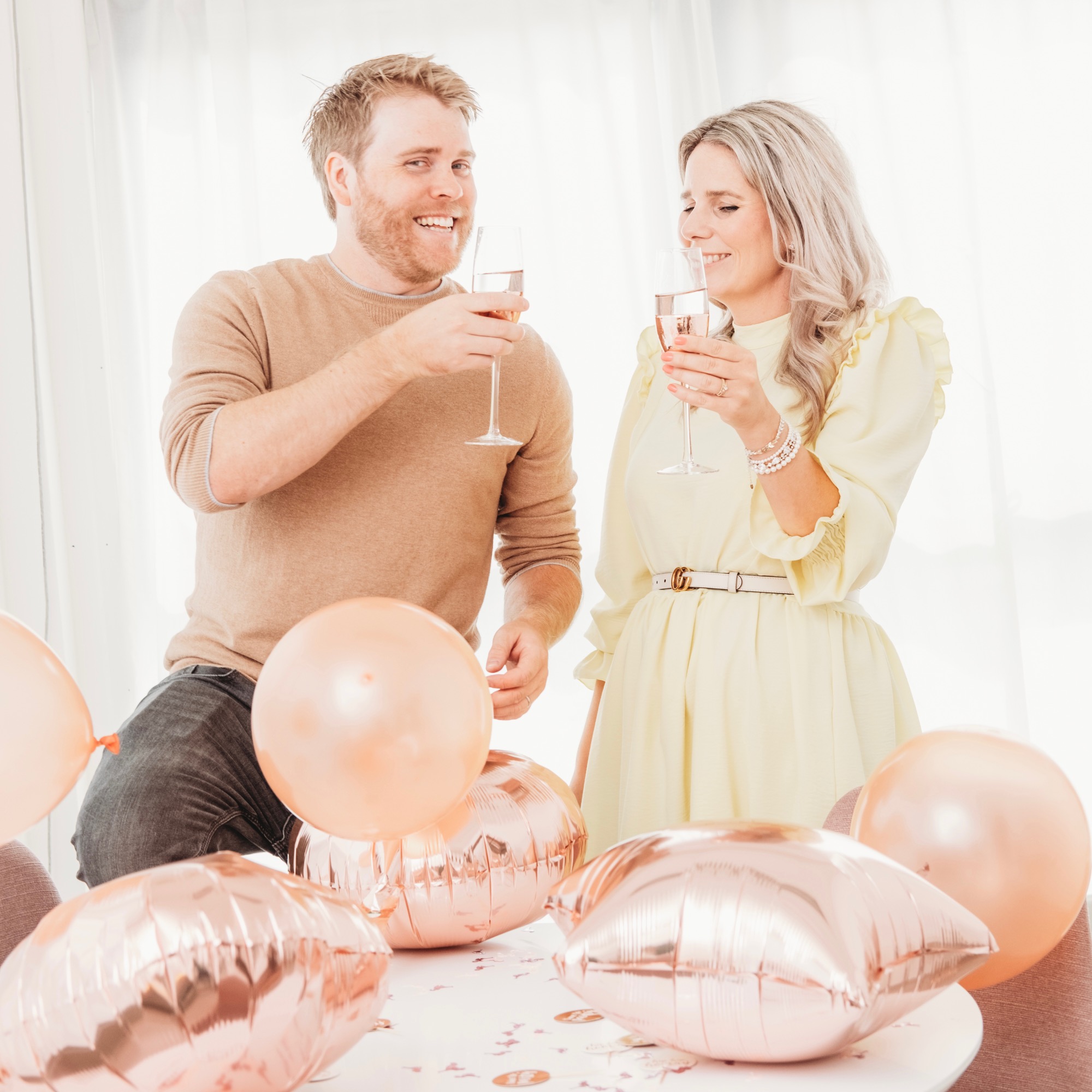 man en vrouw vieren feest met ballonnen en drankje
